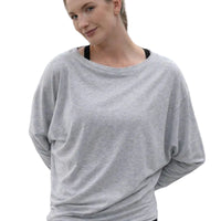 Woman wearing a gray oversized shirt on a city street
