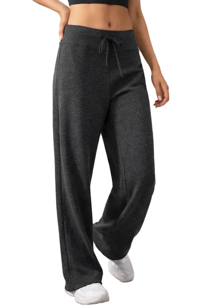 Person wearing dark gray bamboo sweatpants in a casual indoor setting