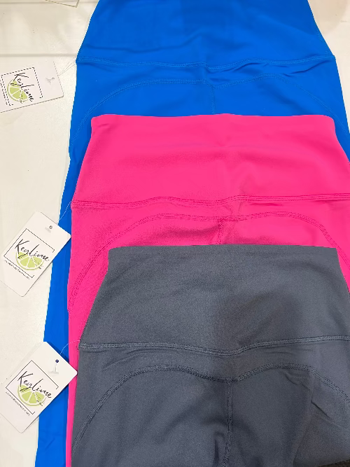 Three pairs of shorts in blue, pink, and gray on a white background.