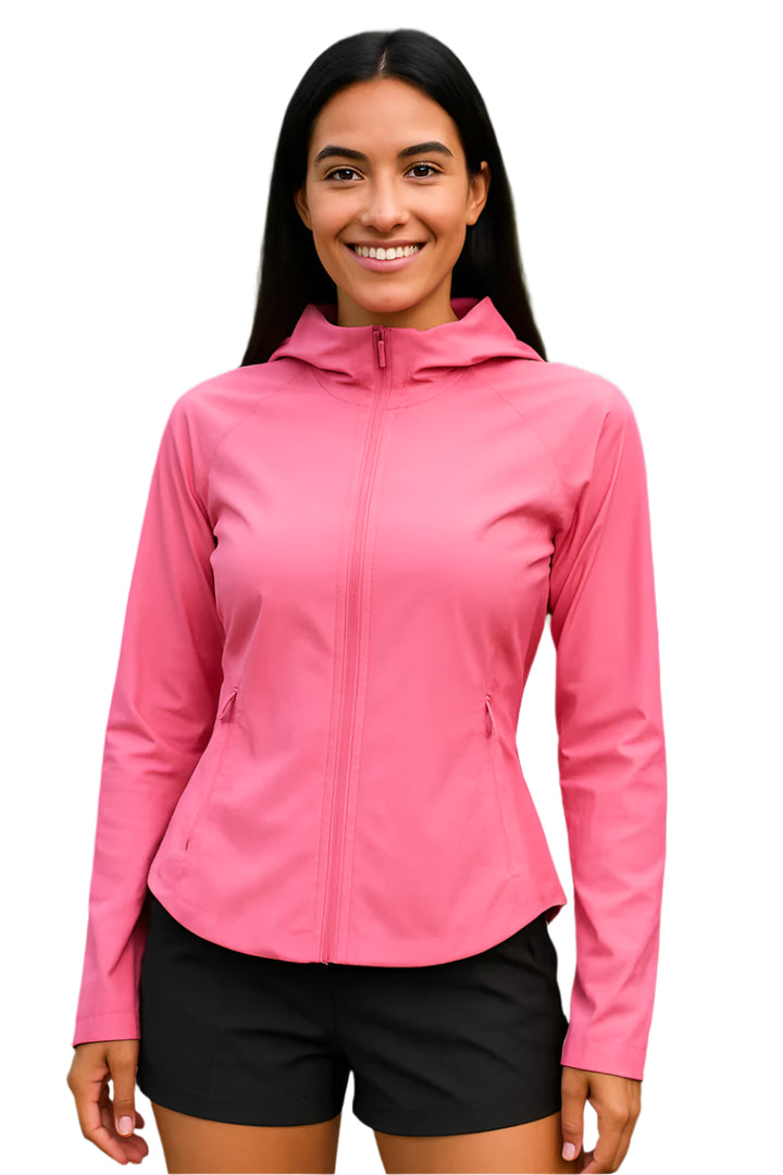 Woman wearing a pink jacket with a hood outdoors