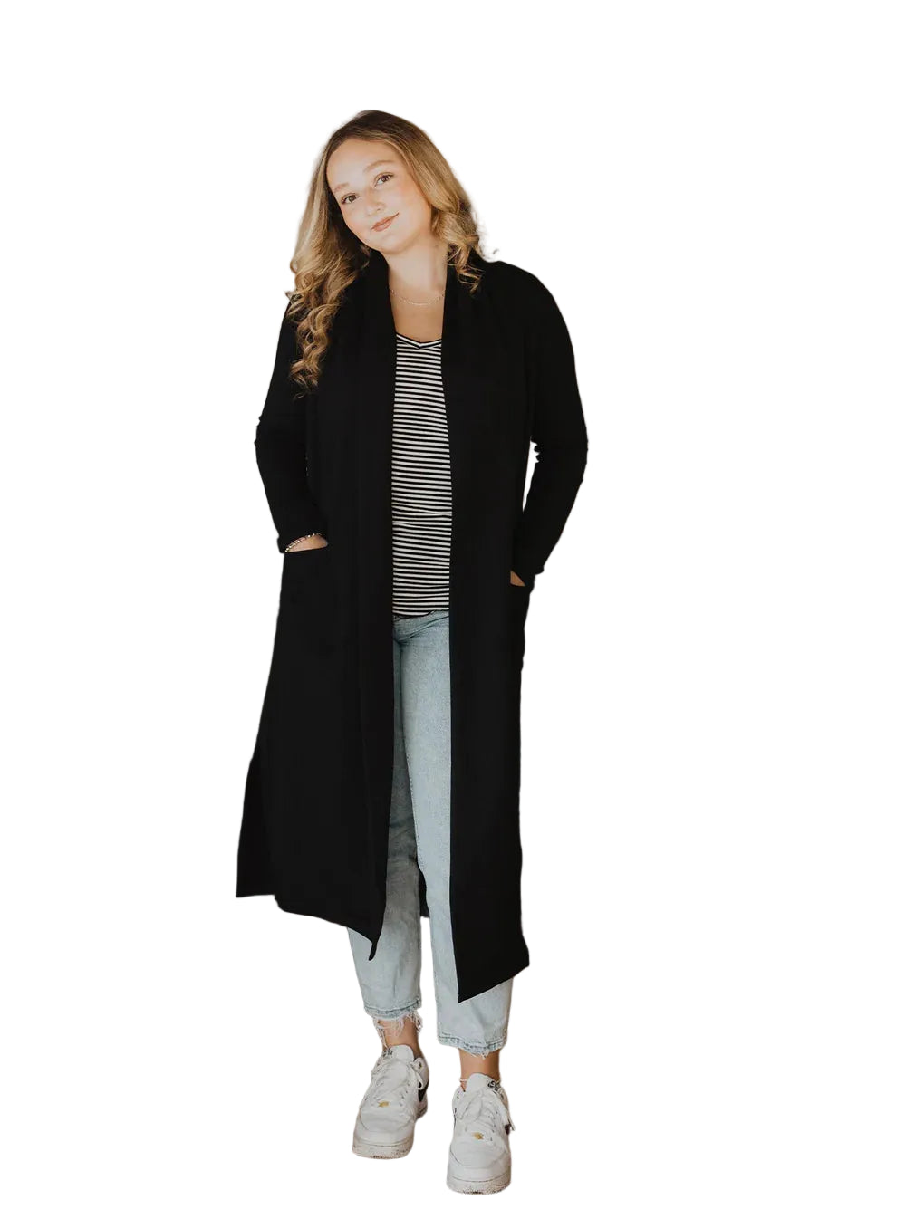 Woman wearing a black coat in a living room setting