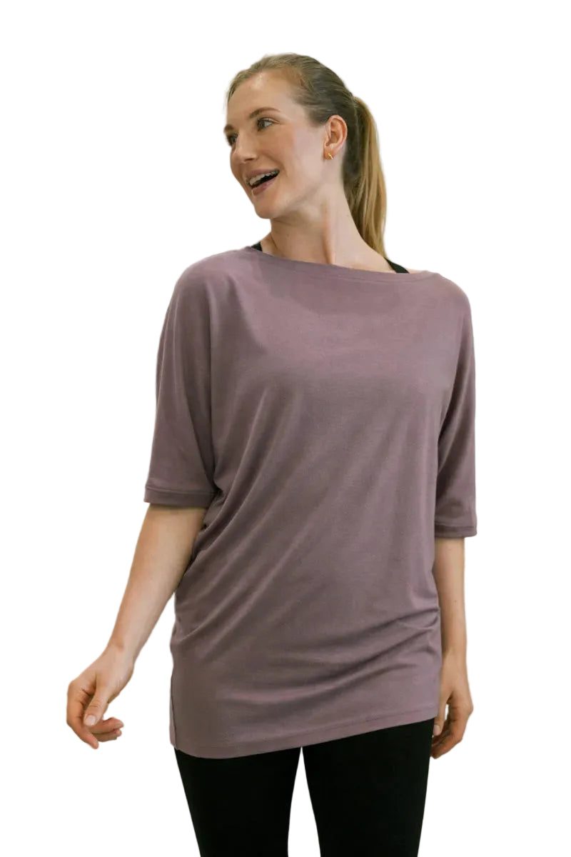 Woman wearing a purple shirt in a clothing store