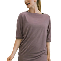Woman wearing a purple shirt in a clothing store